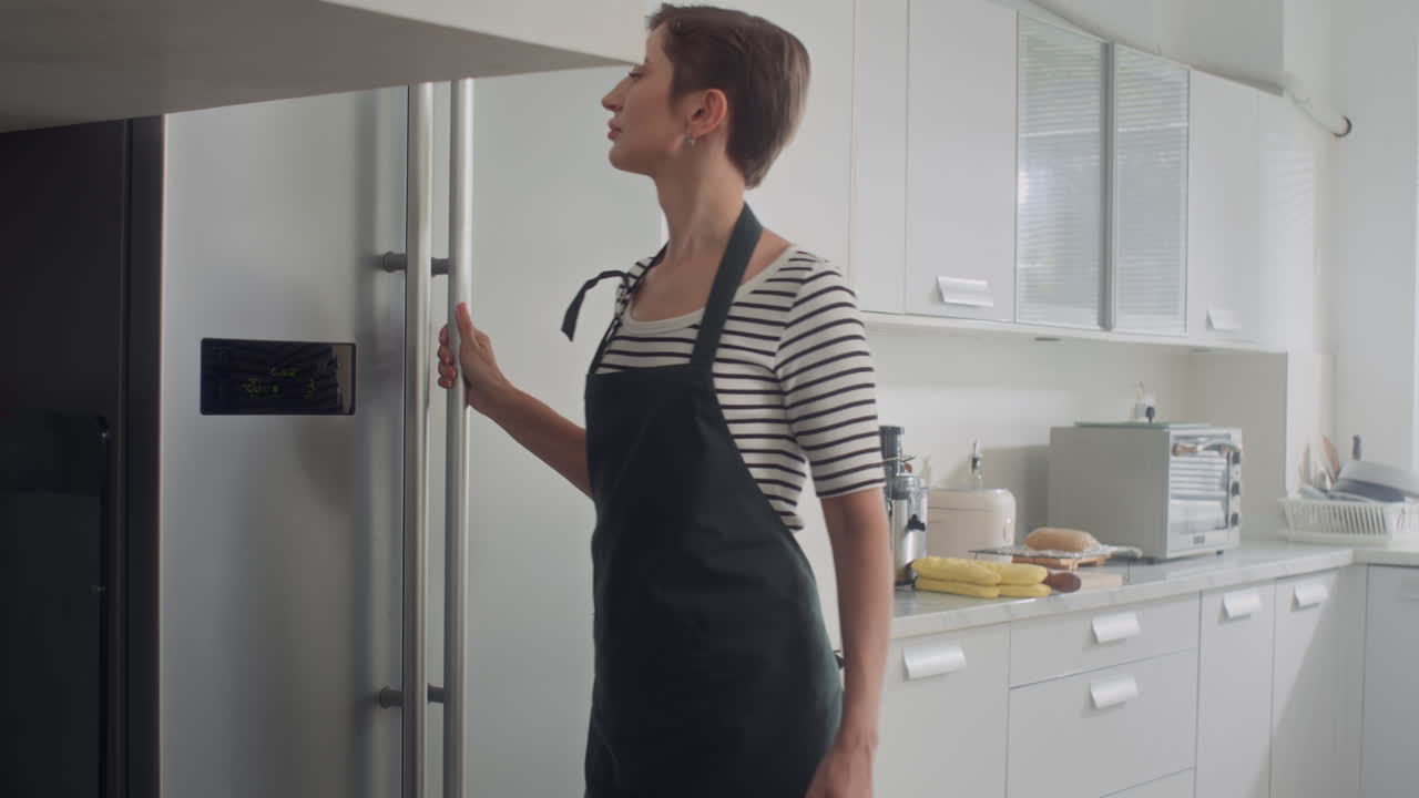 Woman Opening Refrigerator to Take Eggs for Cooking