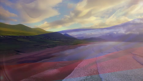 digital composition of columbia flag waving against aerial view of waves in the sea