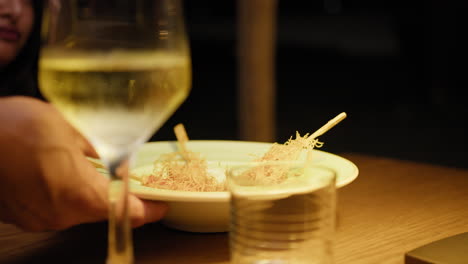 waiter brings the gourmet shrimp dish to the happy woman for dinner