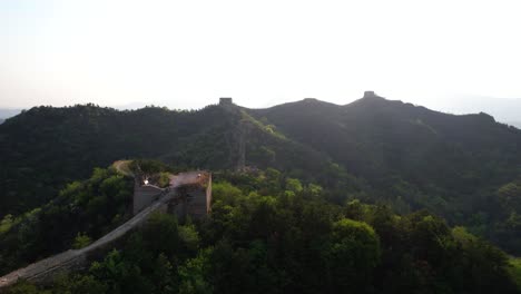 drone quickly rises above chinese great wall at sunset in unrestored section near general tower. gubeikou, panlongshan
