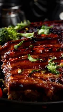 deliciously glazed grilled meat with colorful vegetables on a dark table
