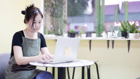 the restaurant manager is surfing the web and communicating. sitting in a coffee cafe, looking over documents.
