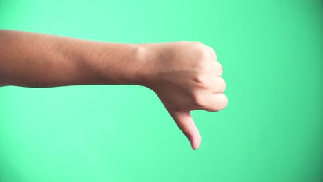 thumbs down gesture on green screen background
