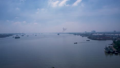 aerial shot of working boats and ships on river on sunny day