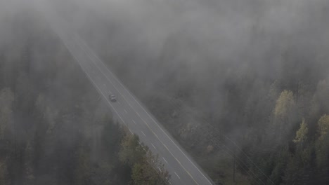 above the mist: aerial capture of cars moving through fog on highway 24 in autumn