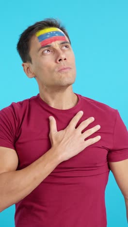 Man listening to the Venezuela national anthem with solemnity