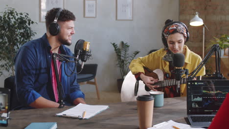 Woman-Playing-Guitar-and-Singing-with-Man-during-Livestream-Show