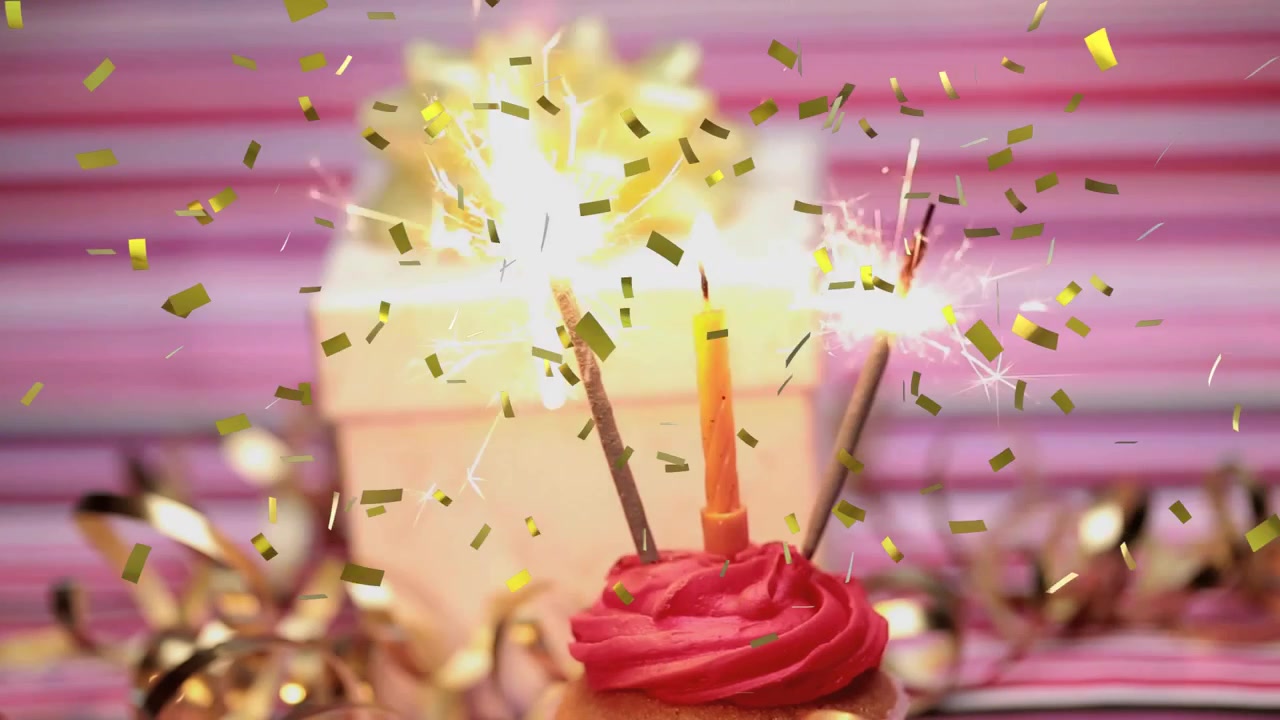 Cupcake festivo di compleanno con stelline accese, candela e coriandoli che cadono