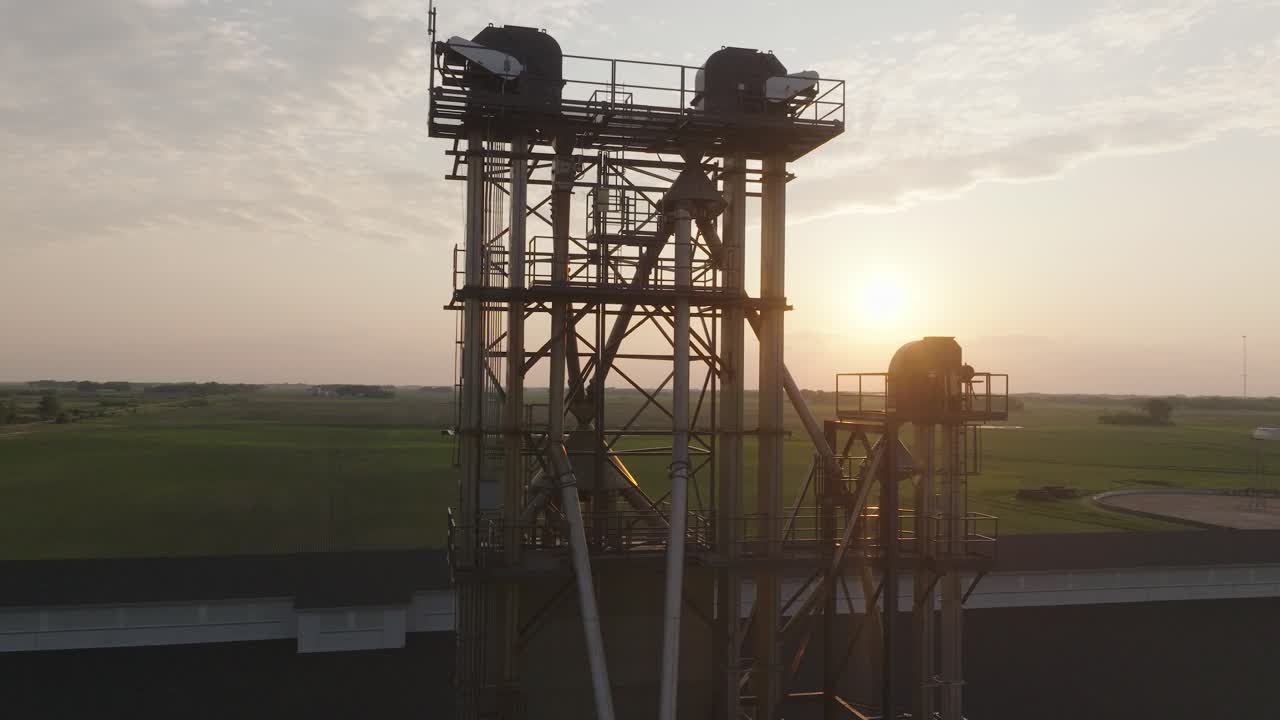 Tall Industrial Fertilizer Elevator Against Rising Sun In Minnesota, USA. drone shot