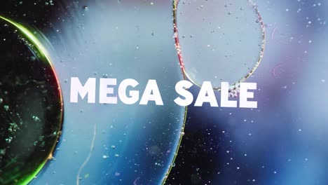 animation of mega sale text over close up of liquid and baubles
