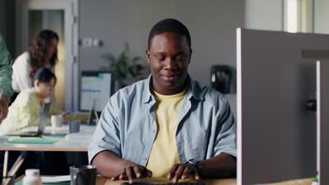 person typing on a keyboard in a modern office