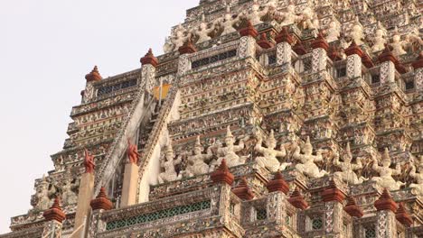 looking-up-at-towering-detailed-pagoda-spires-in-a-Wat-Arun-buddhist-temple-complex-in-the-Rattanakosin-old-town-of-Bangkok,-Thailand