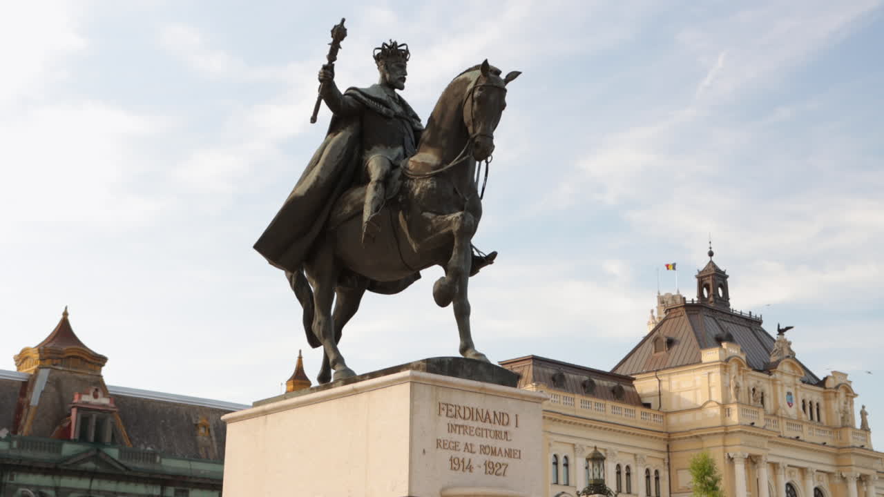 King Ferdinand I of Romania Statue At Unirii Square With City Hall Of Oradea In Background. wide shot