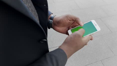 Businessman-scrolling-smartphone-outside.-Male-entrepreneur-working-on-phone