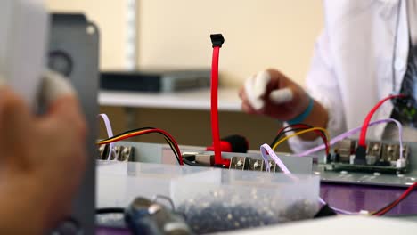 the engineer secures the motherboard to the chassis with screws