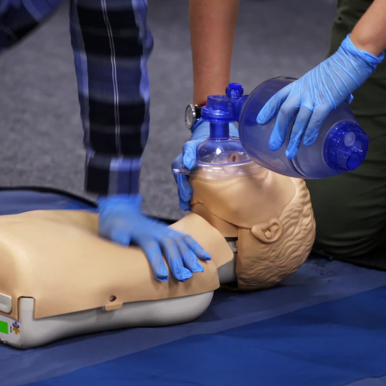 Medical male dummy on blue hospital blanket. Medical equipments for education. First aid training video