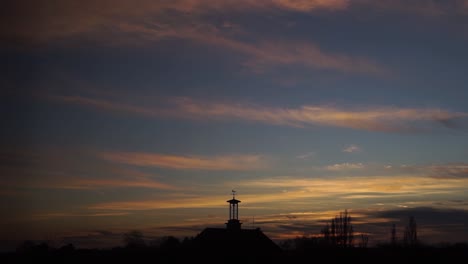 cirrus clouds moving slow at sunset sky time lapse silhouette clock tower