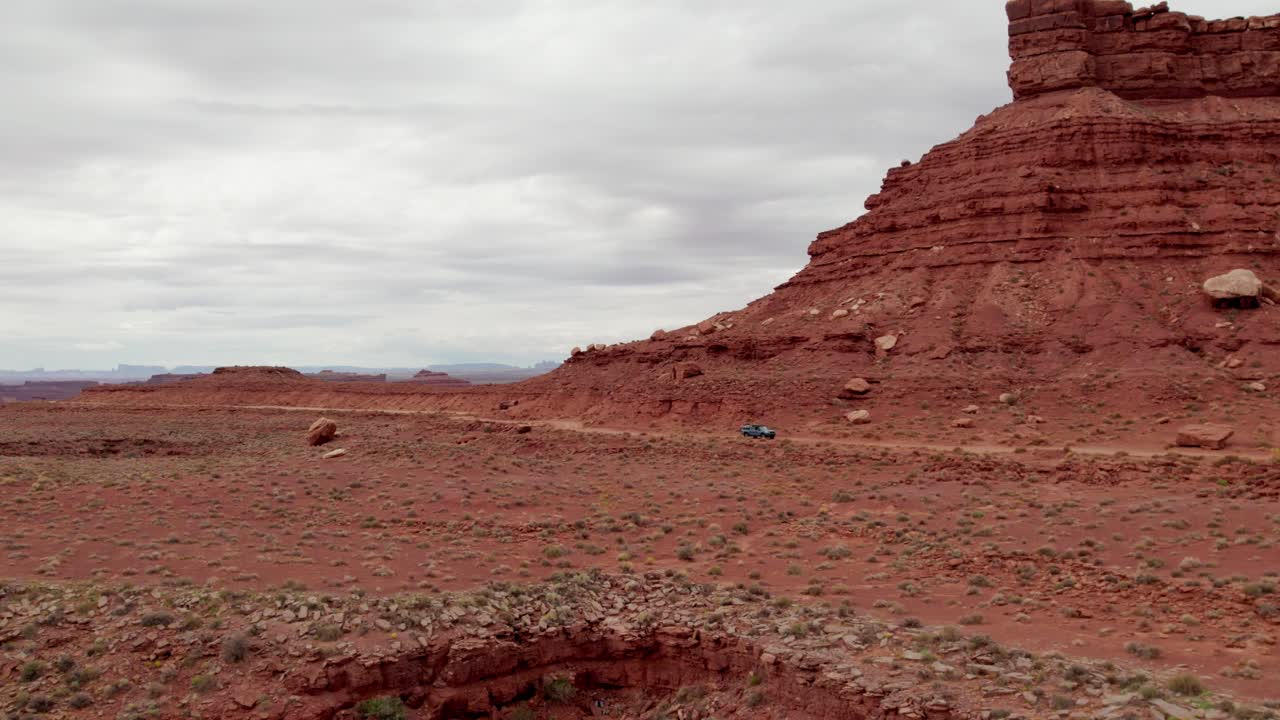 Car driving by Rock Formations, Valley of the Gods, Utah, United States