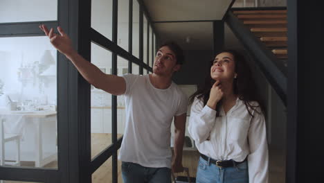 Tourist-couple-entering-house-with-suitcase