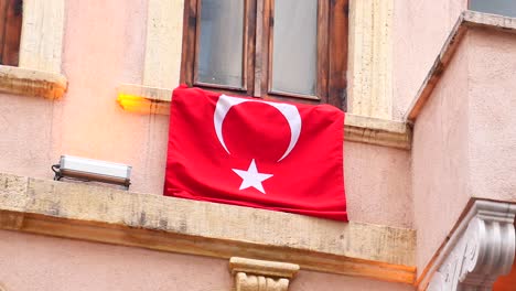 turkish flag hanging from a building window