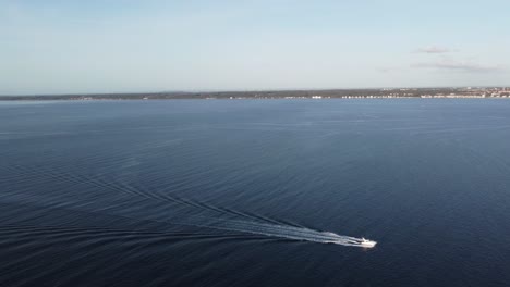 aerial-view-of-a-ship-crossing-the-oresund-strait,-in-front-of-kronborg-castle-with-a-view-towards-sweden