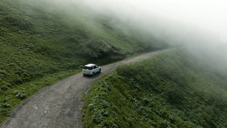 foggy clouds covering tskhratskaro pass with driving vehicle in georgia