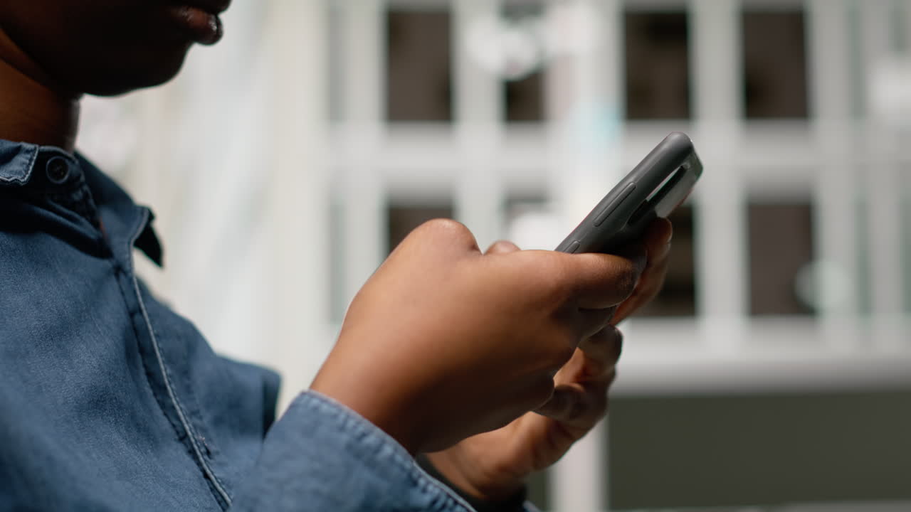 Primo piano di una donna di colore che usa lo smartphone per ottenere indicazioni stradali su un'app