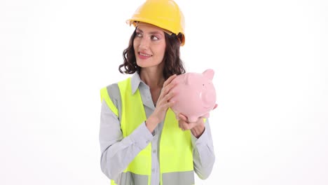 female engineer or construction worker saving money in a piggy bank