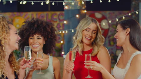 Multi-Cultural-Group-Of-Female-Friends-Celebrating-Making-Toast-Enjoying-Party-Night-Out-In-Bar