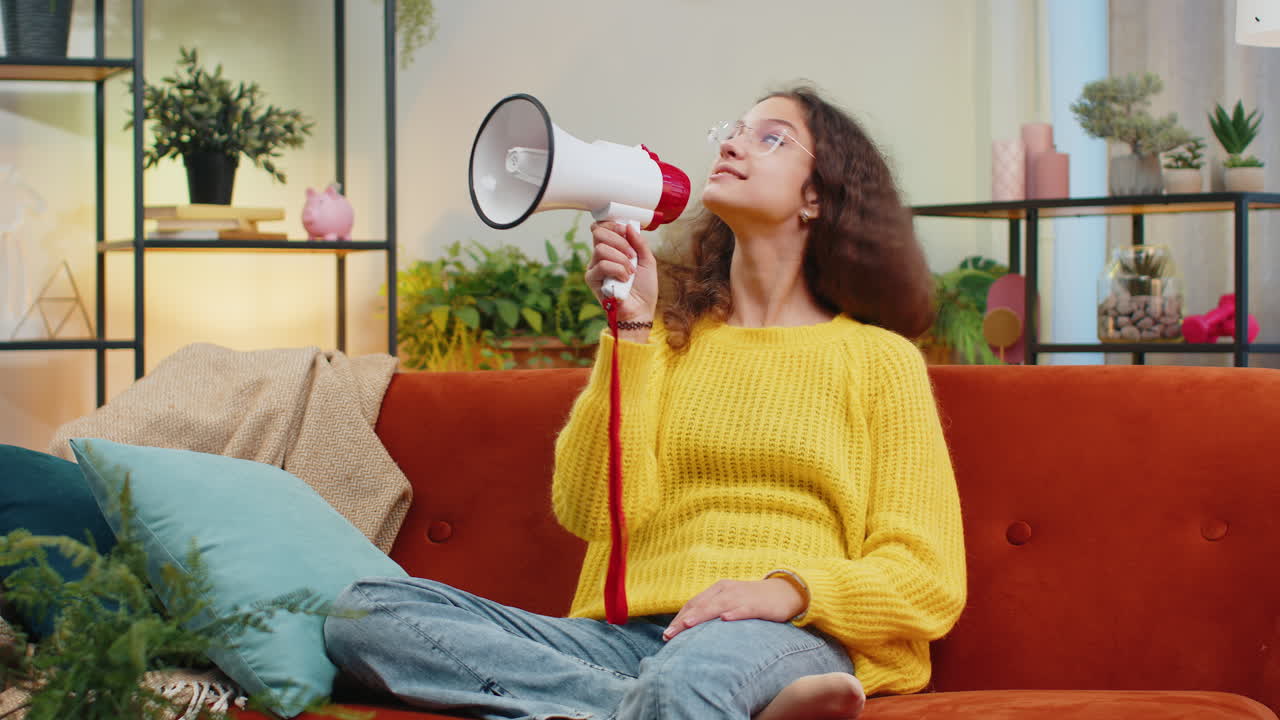 Teenager child girl kid talking with megaphone proclaiming news loudly announcing advertisement