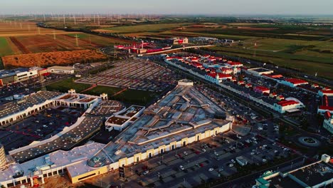 drone view reveals shopping complex and vast rural lands in northern austria