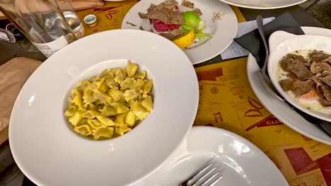 agnolotti and truffle dishes served at a table