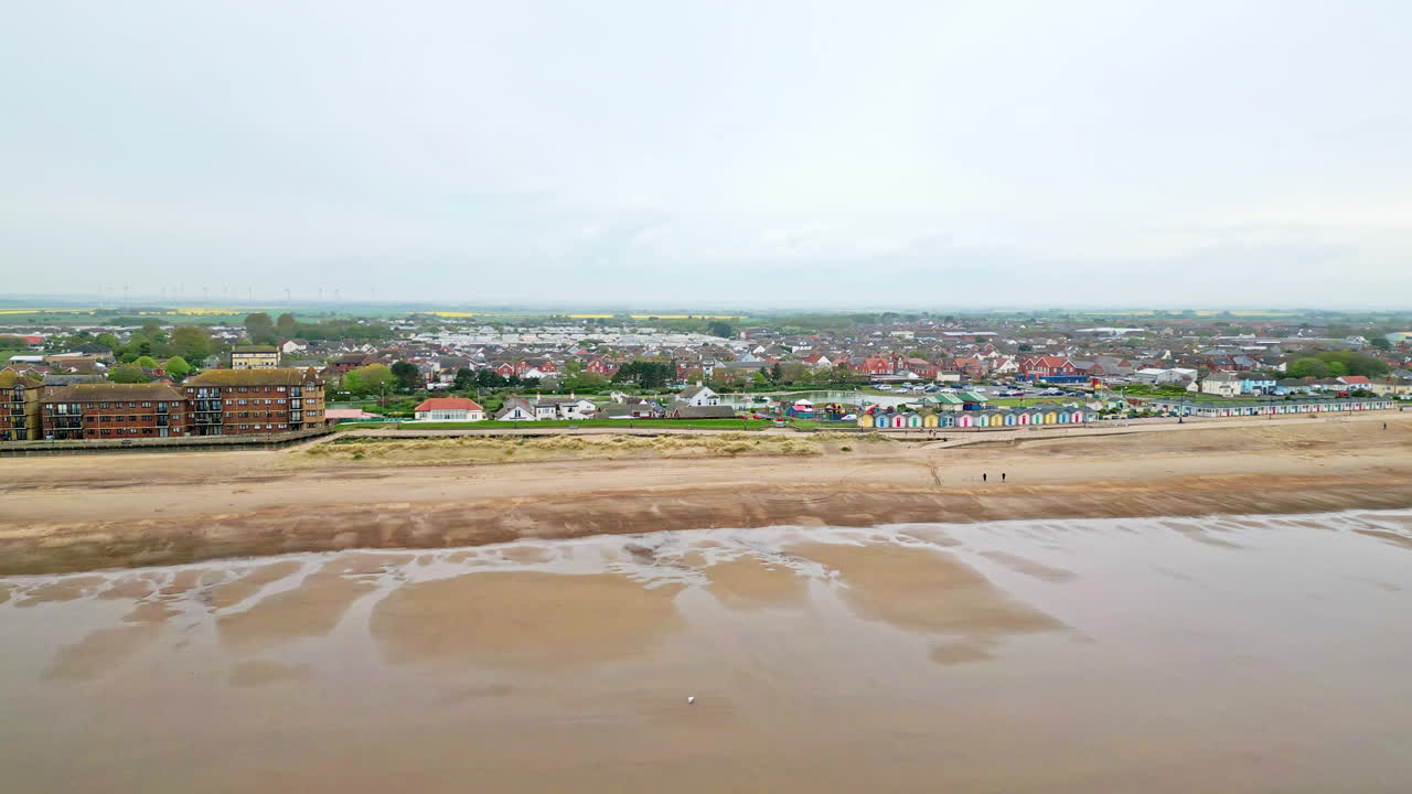See Mablethorpe's coastal allure like never before in aerial video, showcasing beach huts, sandy beaches, amusement parks, rides, and the holidaymakers' joy
