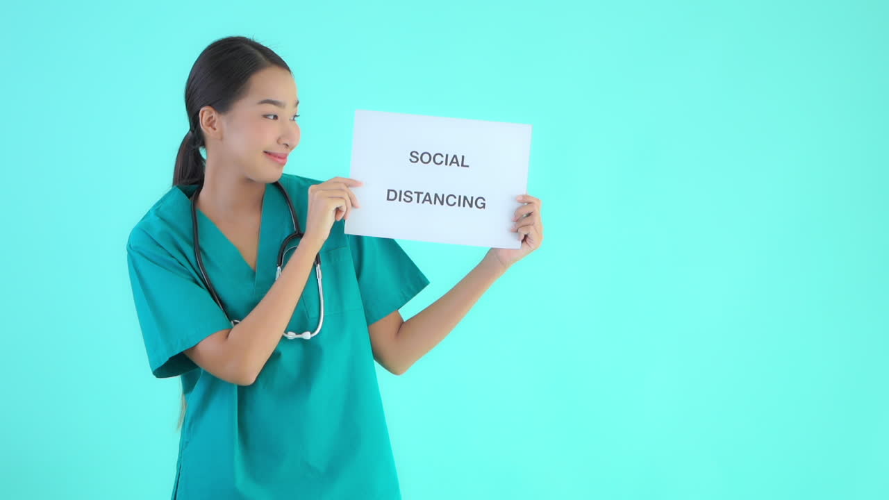 Asian female doctor spreading awareness regarding social distancing