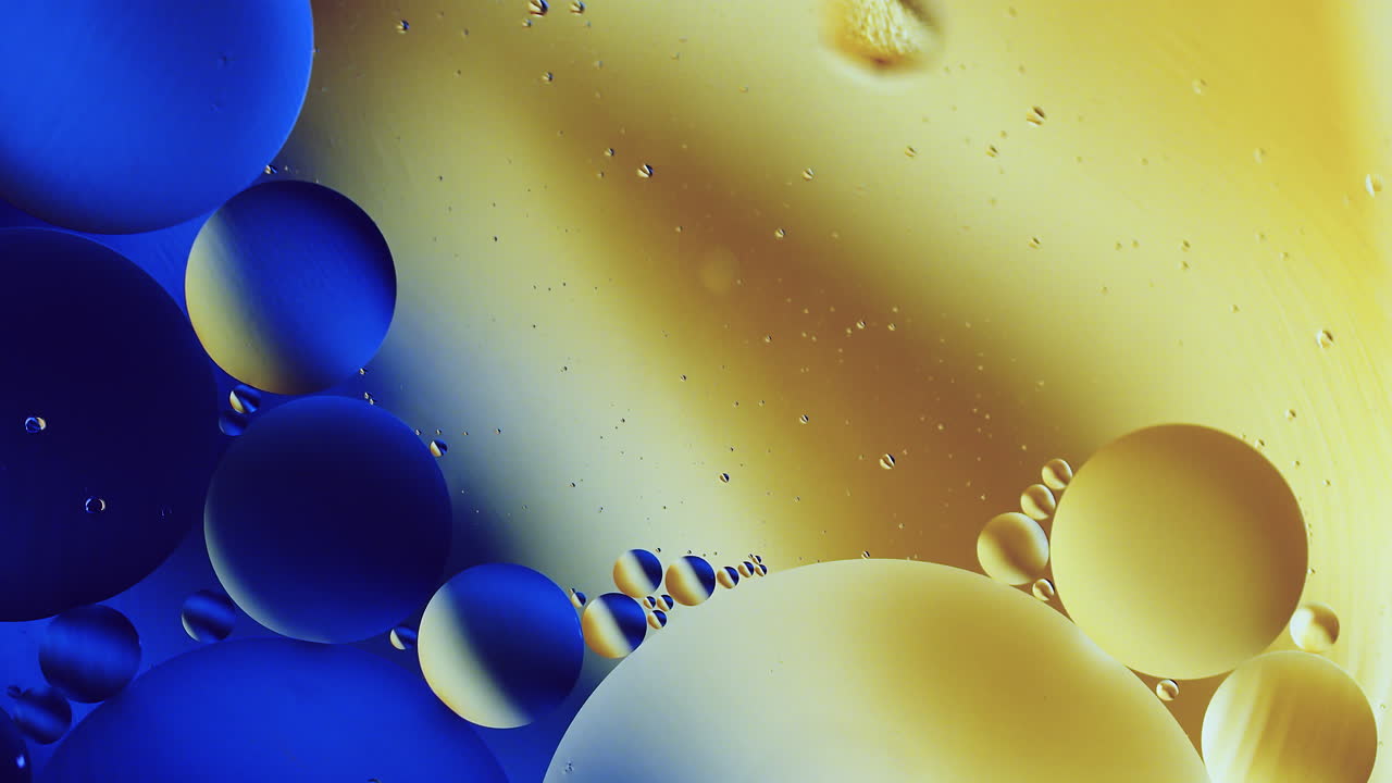 Real abstract colourful oil drops in water rotation with color gradient mixing background