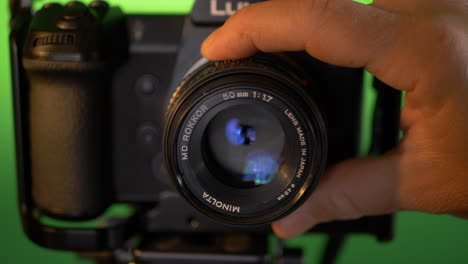 dolly in on modern full frame mirrorless camera with vintage 50mm lens with aperture being opened up.