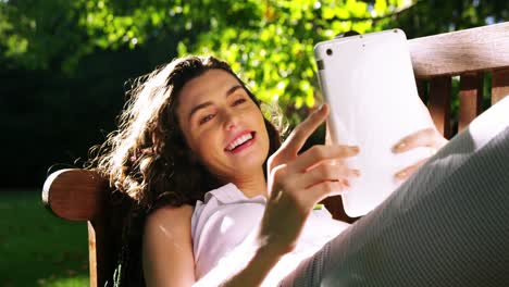 hermosa mujer usando una tableta digital en el jardín