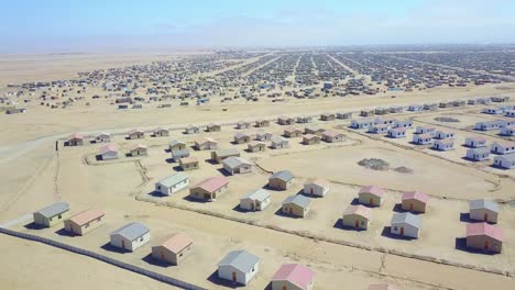 aerial over a strange abandoned town of empty lonely suburban tract houses in the desert of namibia africa