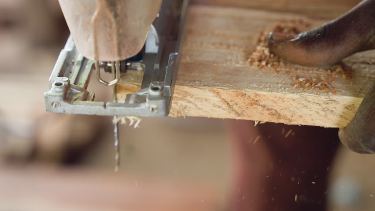 Carpenter trims with skillful precision. Skilled craftsman shapes wood with careful expertise. Detailed scene of carpenter using hand and saw to craft wood meticulously in workshop environment