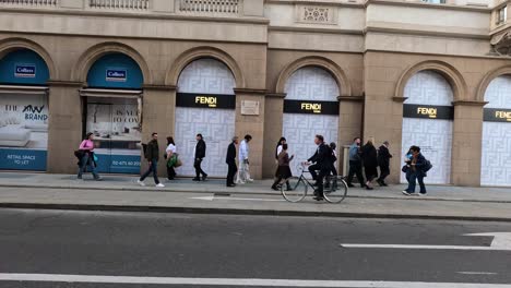 pedestrians and cyclists on a busy street