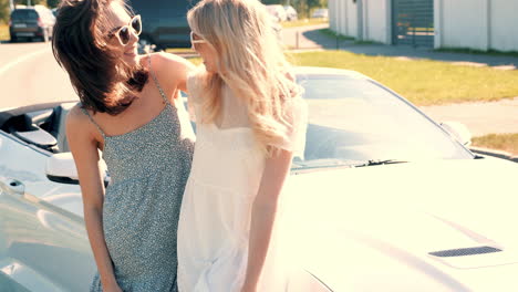 two girls having fun in a convertible