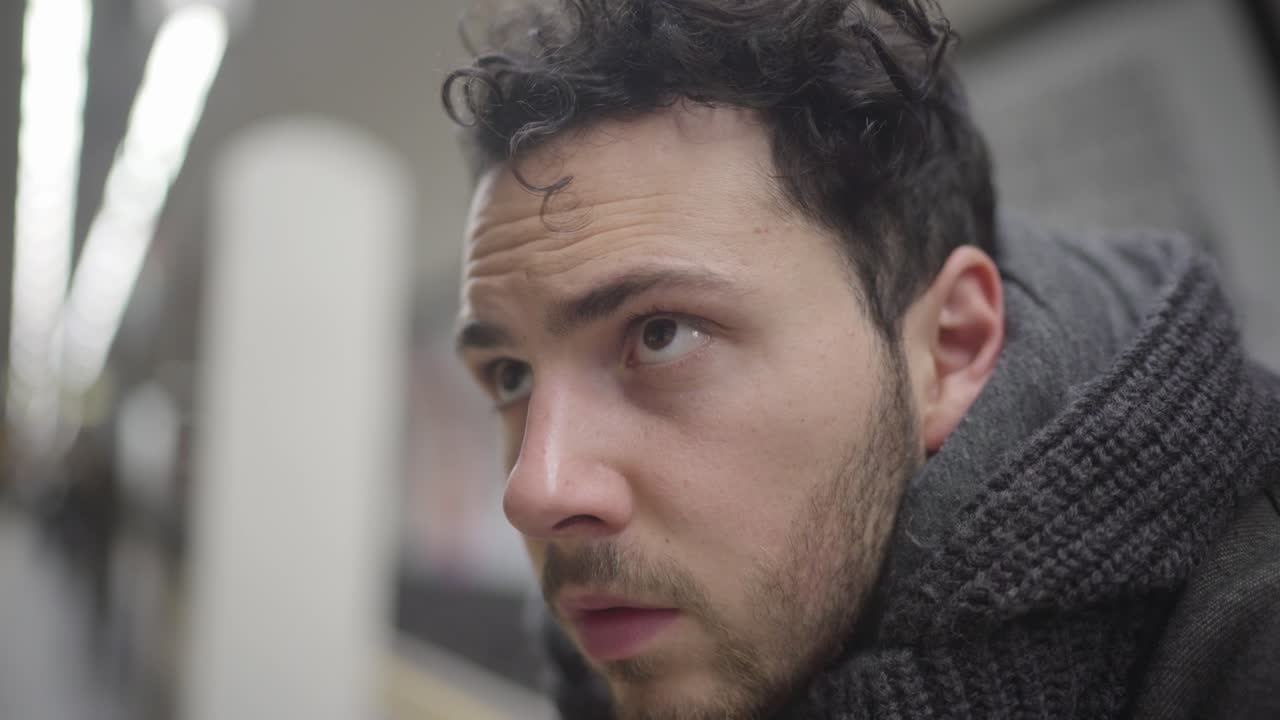 An unhappy and depressed guy on metro looks like worried and thoughtful about his future. A sad face expression on him