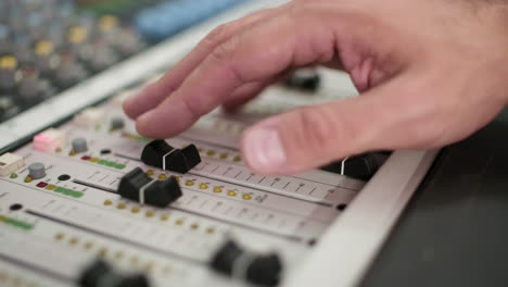 adjusting sound level on audio mixing console