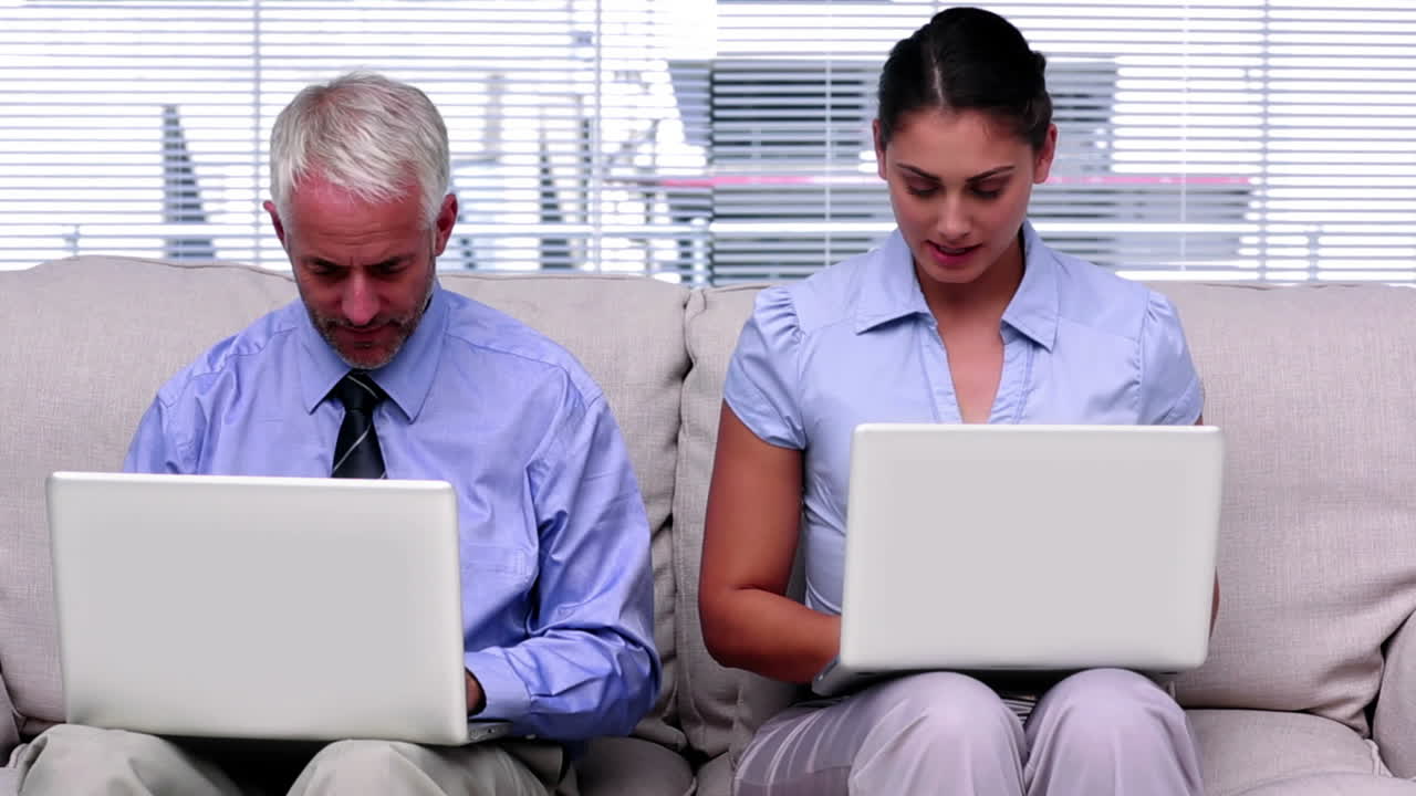 Business people working on laptops
