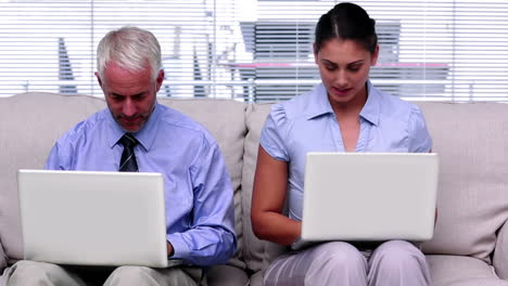 Business-people-working-on-laptops