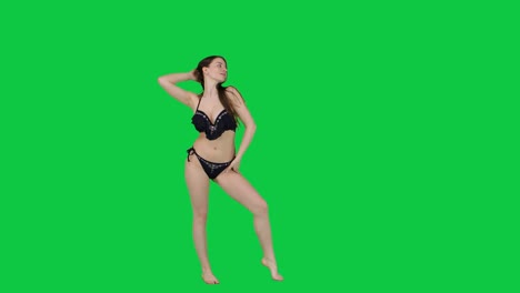 Attractive-female-model-in-a-bikini-posing-in-front-of-a-green-screen