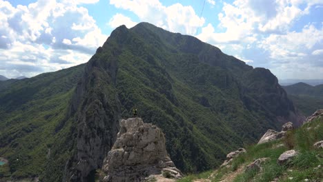 lonely tourist on rock formation, lake bovilla, albania