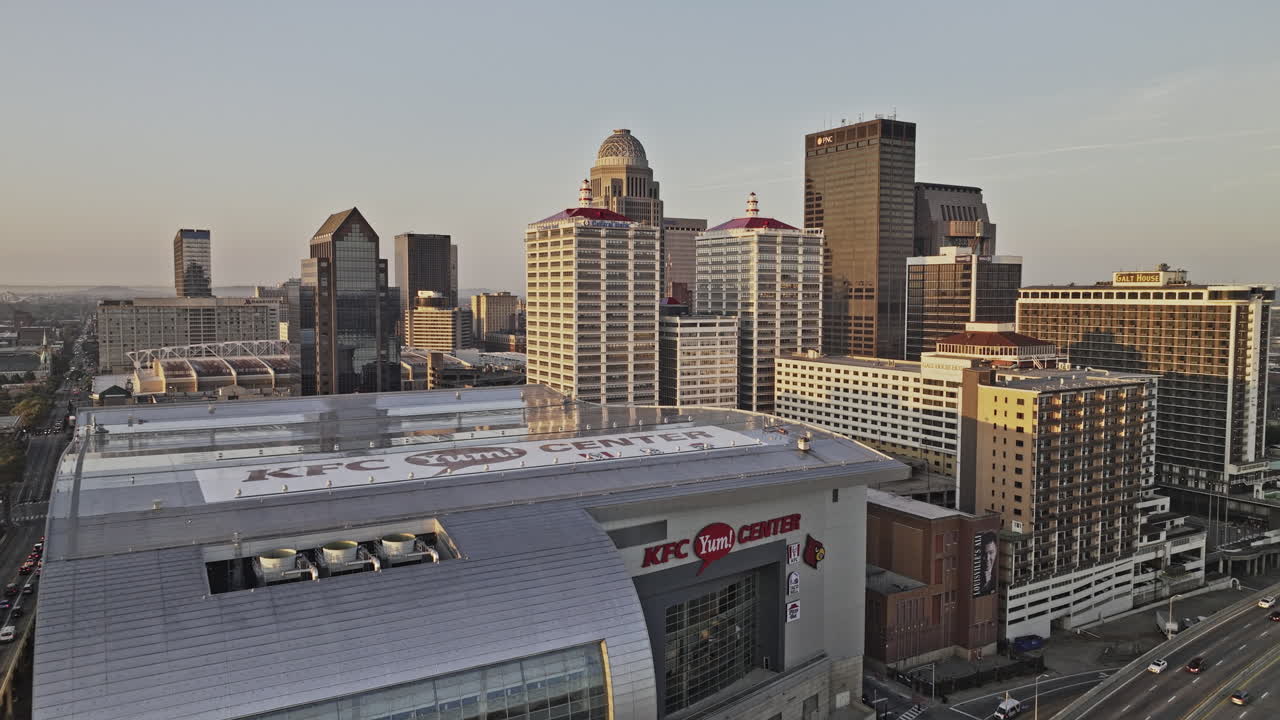 Louisville Kentucky Aerial v63 low drone flyover memorial bridge and indoor arena capturing riverside freeway traffic and downtown cityscape at sunrise - Shot with Mavic 3 Pro Cine - Sept 26th 2023