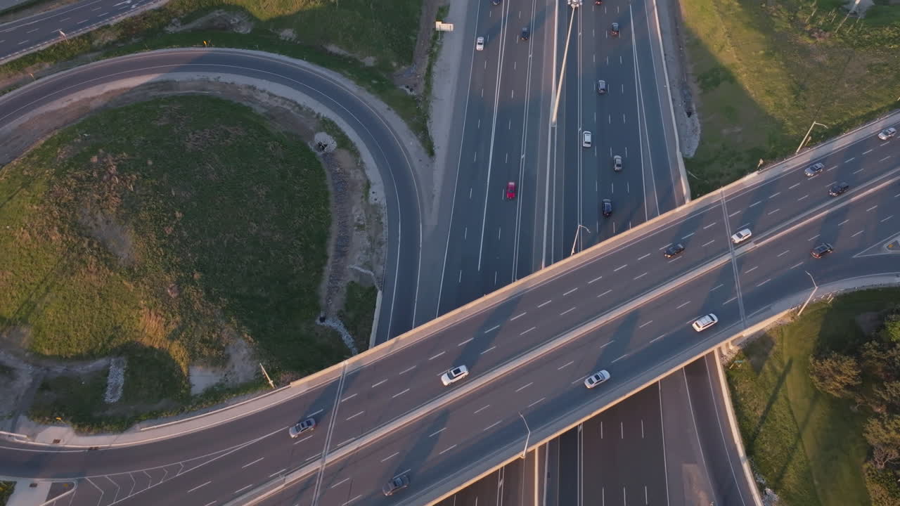 Mississauga highway 401 with vehicles moving along the overpass in slow motion, aerial view