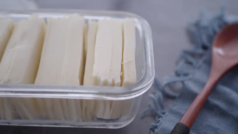 sliced white cheese in a container